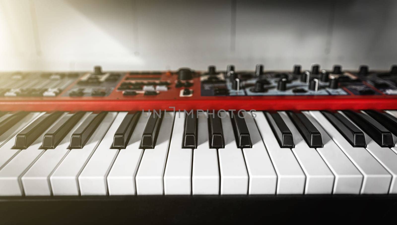 Electronic piano black and white keyboard coseup. Musical pianoforte synthesizer in recording studio for professional music creation