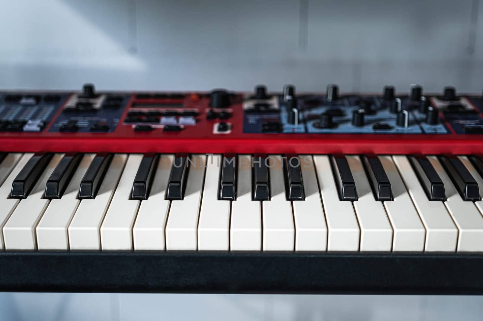 Electronic piano black and white keyboard coseup. Musical pianoforte synthesizer in recording studio for professional music creation