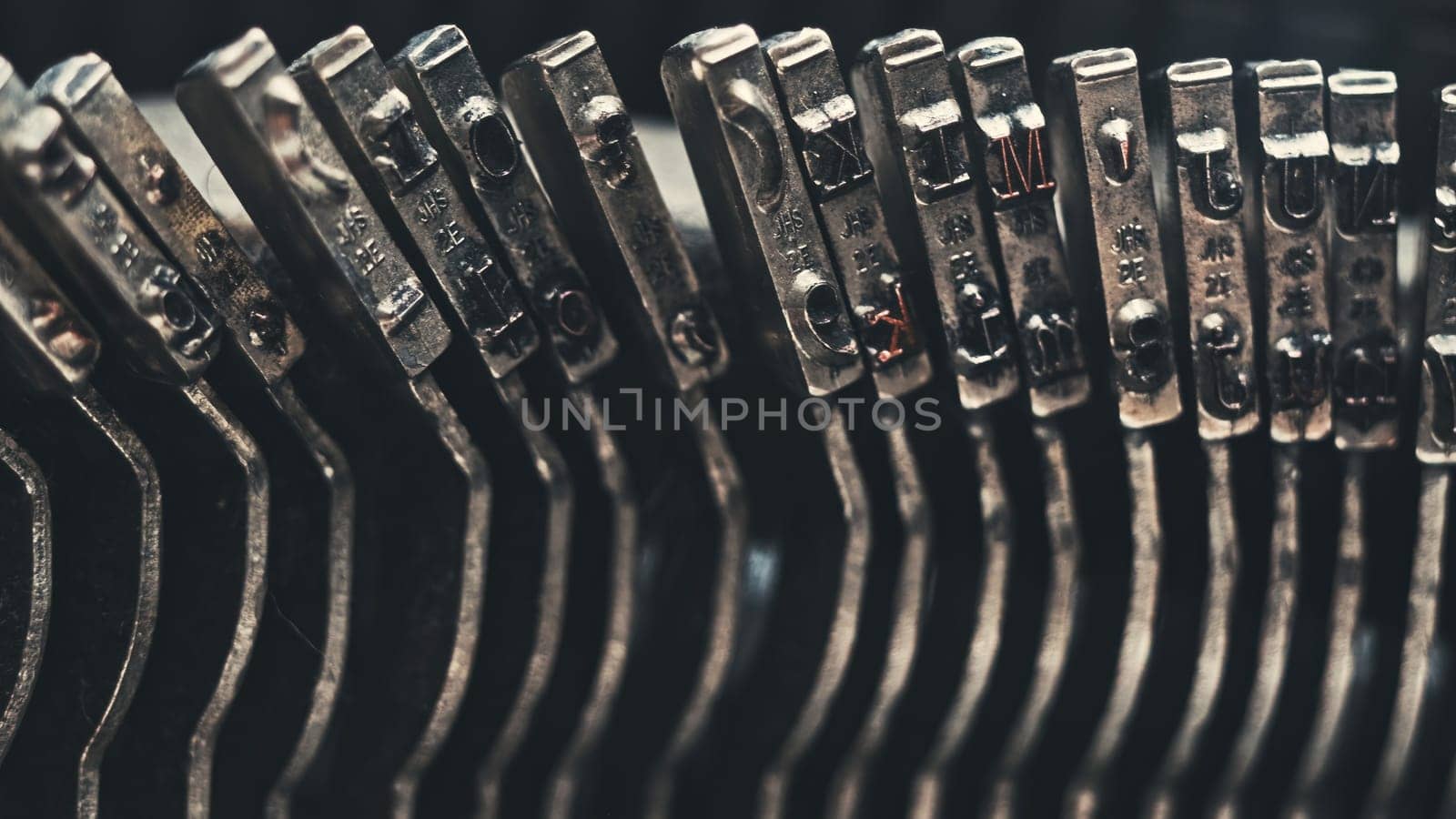Letters and numbers on typo keys of an old manual typewriter on a retro writing machine, close up view