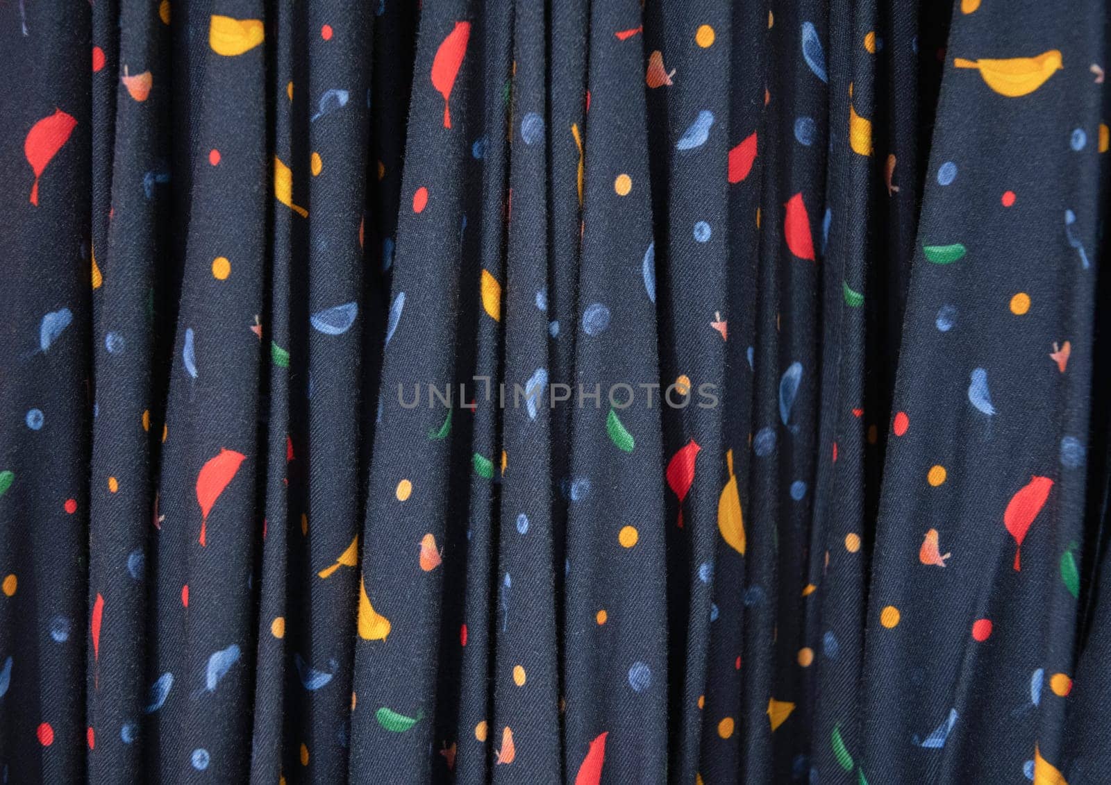 dark blue with colorful spots summer blouses on a hanger in the store, bright summer clothes, abstract textured pattern, High quality photoHigh quality photo