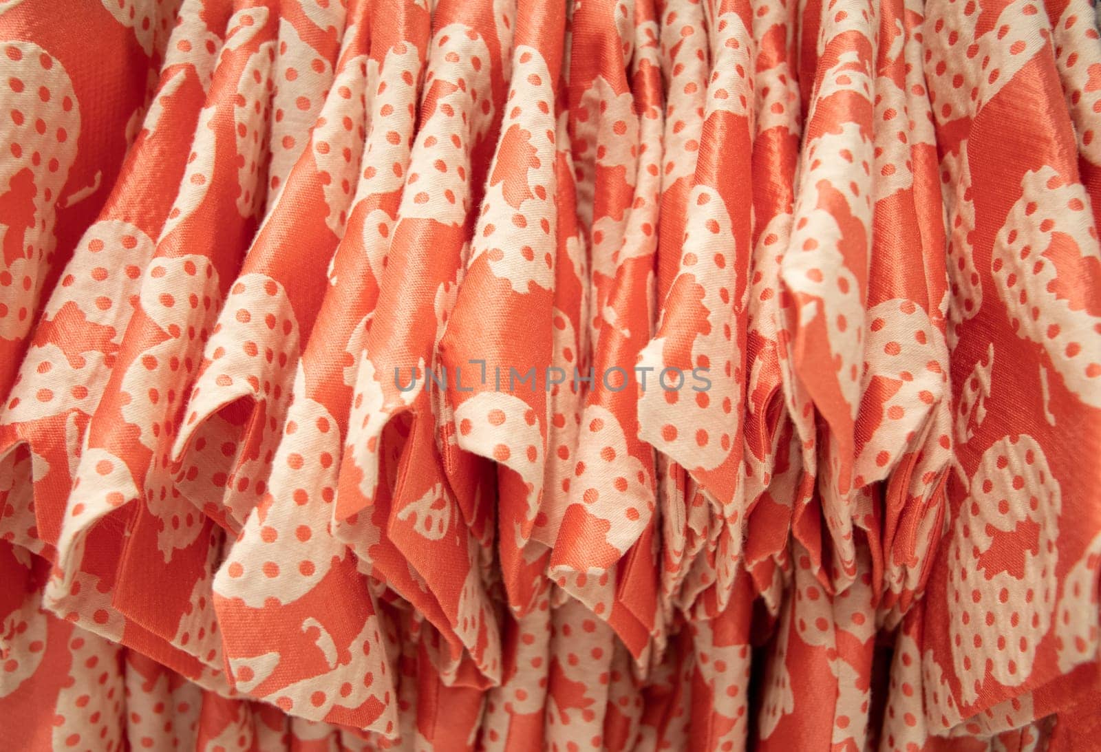 many same models orange blouses in the store in the same color on a hanger, bright summer colors of fashion clothes, High quality photo