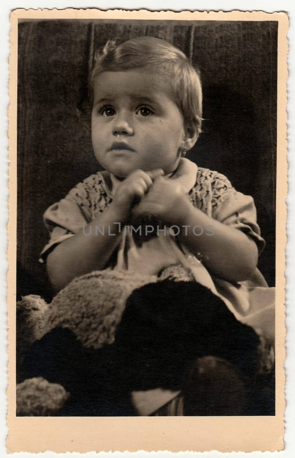 Vintage photo shows cute small girl. Black white antique studio portrait. by roman_nerud