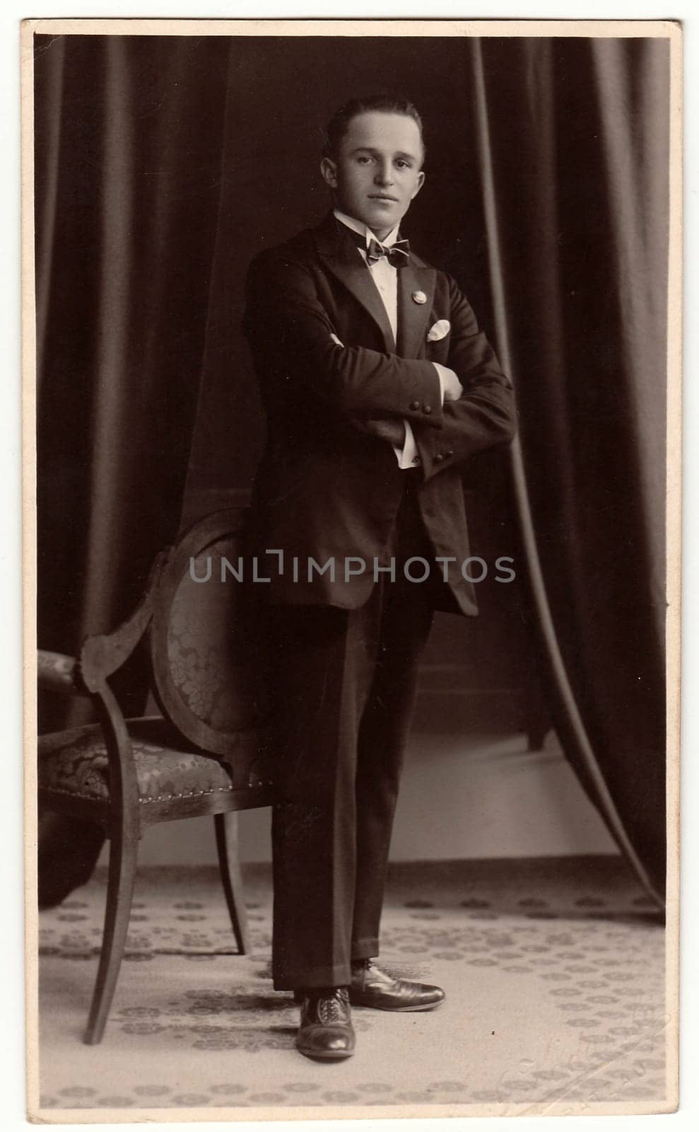 CHRASTAVA (KRATZAU), THE CZECHOSLOVAK REPUBLIC - CIRCA 1930s: Vintage photo shows an elegant man poses in a photography studio. Black white studio portrait.