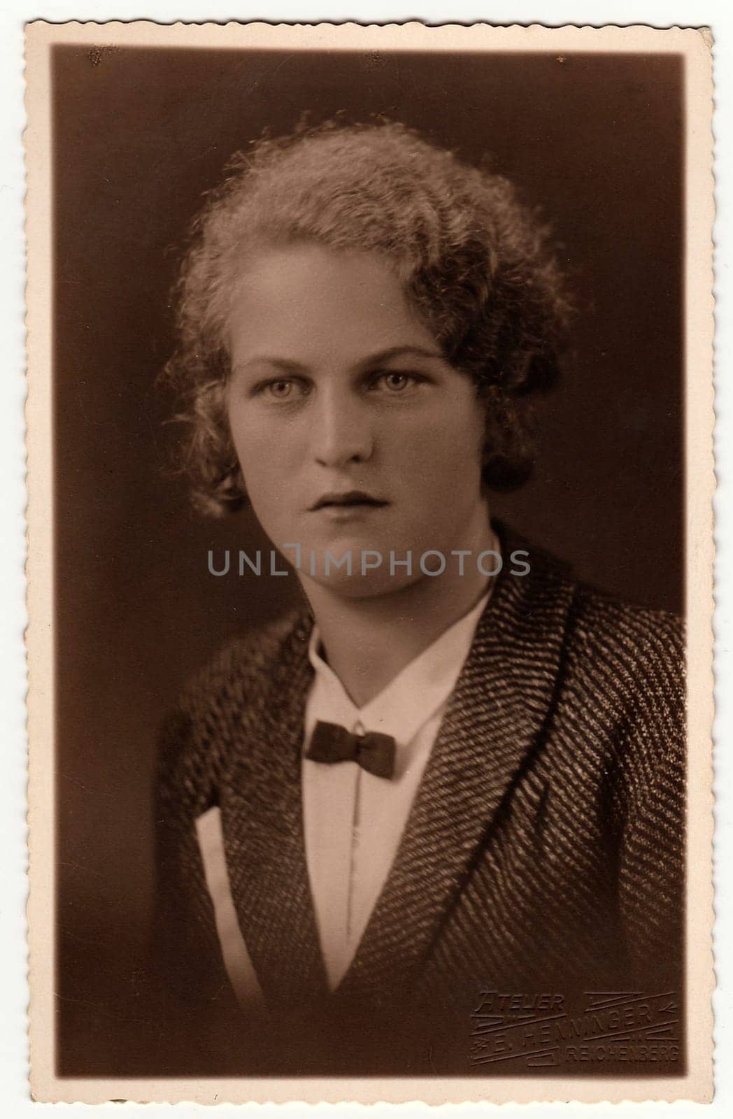 Vintage photo shows woman poses in a photography studio. Photo with dark sepia tint. Black white studio portrait. by roman_nerud