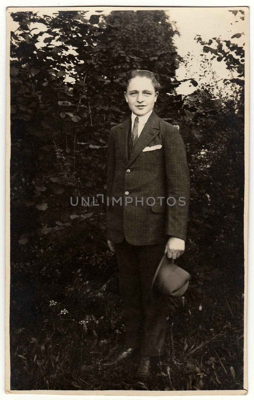 THE CZECHOSLOVAK REPUBLIC - CIRCA 1940s: Vintage photo shows man wears suit with an elegant hat poses outdoors. Black white antique photo.