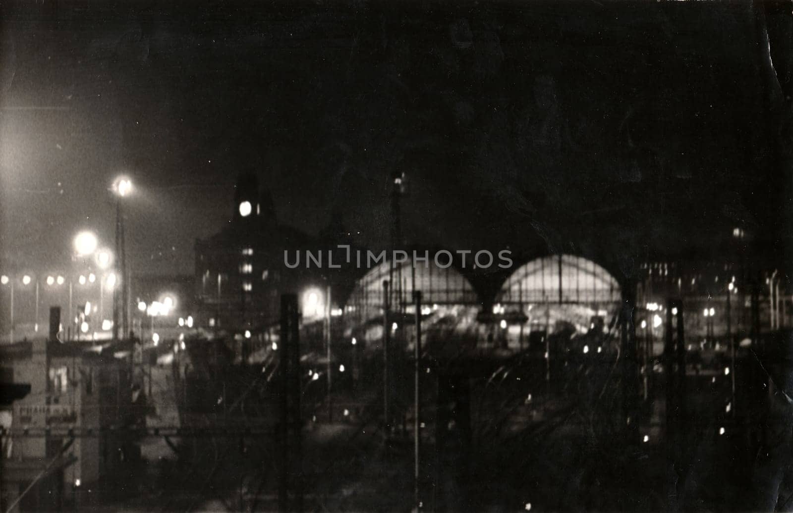 Vintage photo shows night view on Prague main railway station. Black white antique photo. by roman_nerud