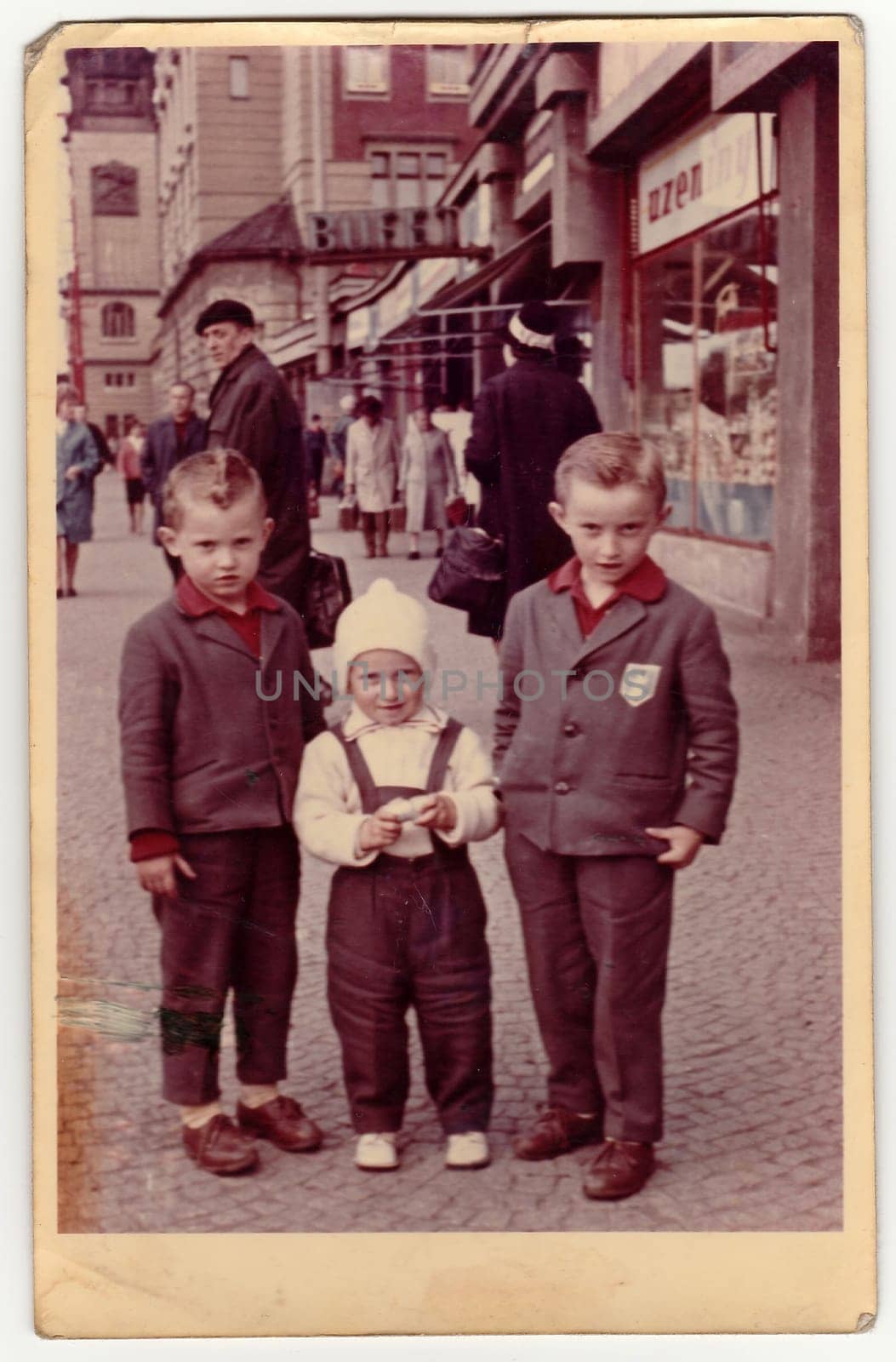 Vintage photo shows children boys pose on the city street. by roman_nerud