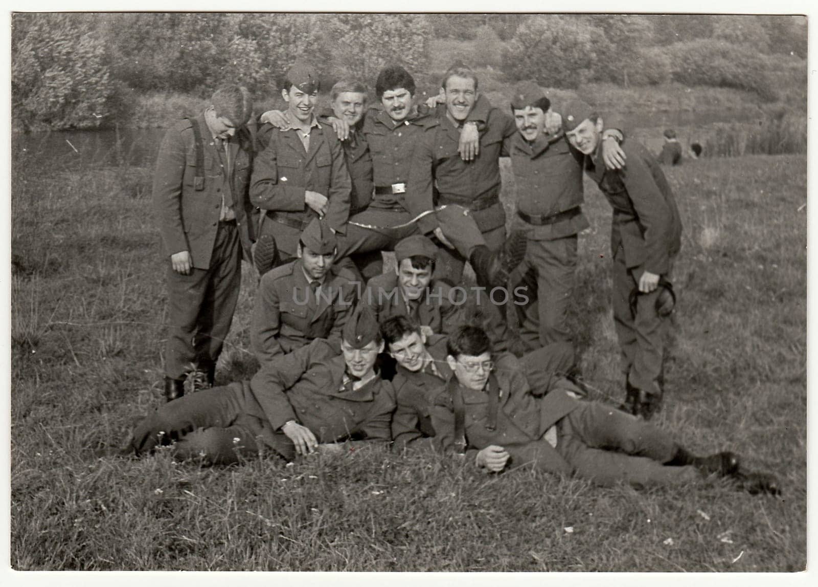 Vintage photo shows soldiers pose outdoors. Black & white antique photo. by roman_nerud