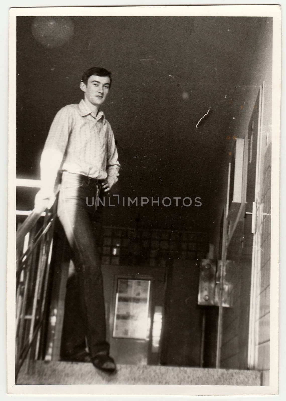 Vintage photo shows boy in the hall of residence (dormitory). Antique black & white photography. by roman_nerud