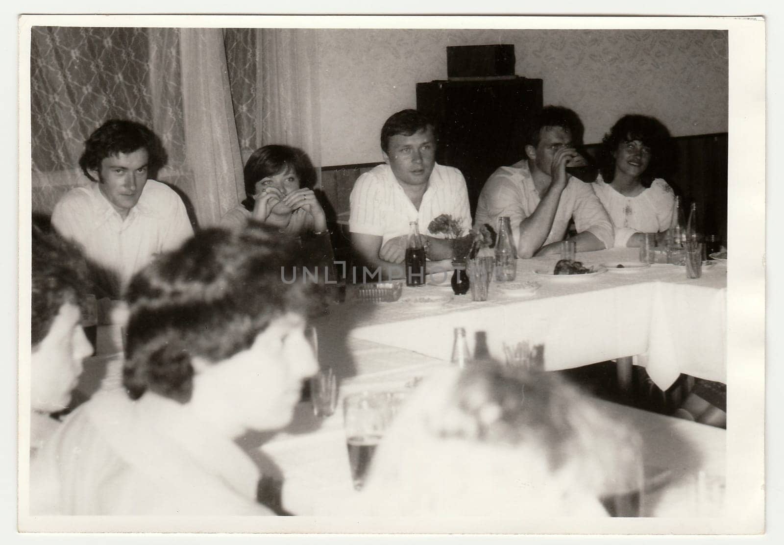 THE CZECHOSLOVAK SOCIALIST REPUBLIC - CIRCA 1980s: Vintage photo shows a group of people during party indoors. Black & white antique photography.