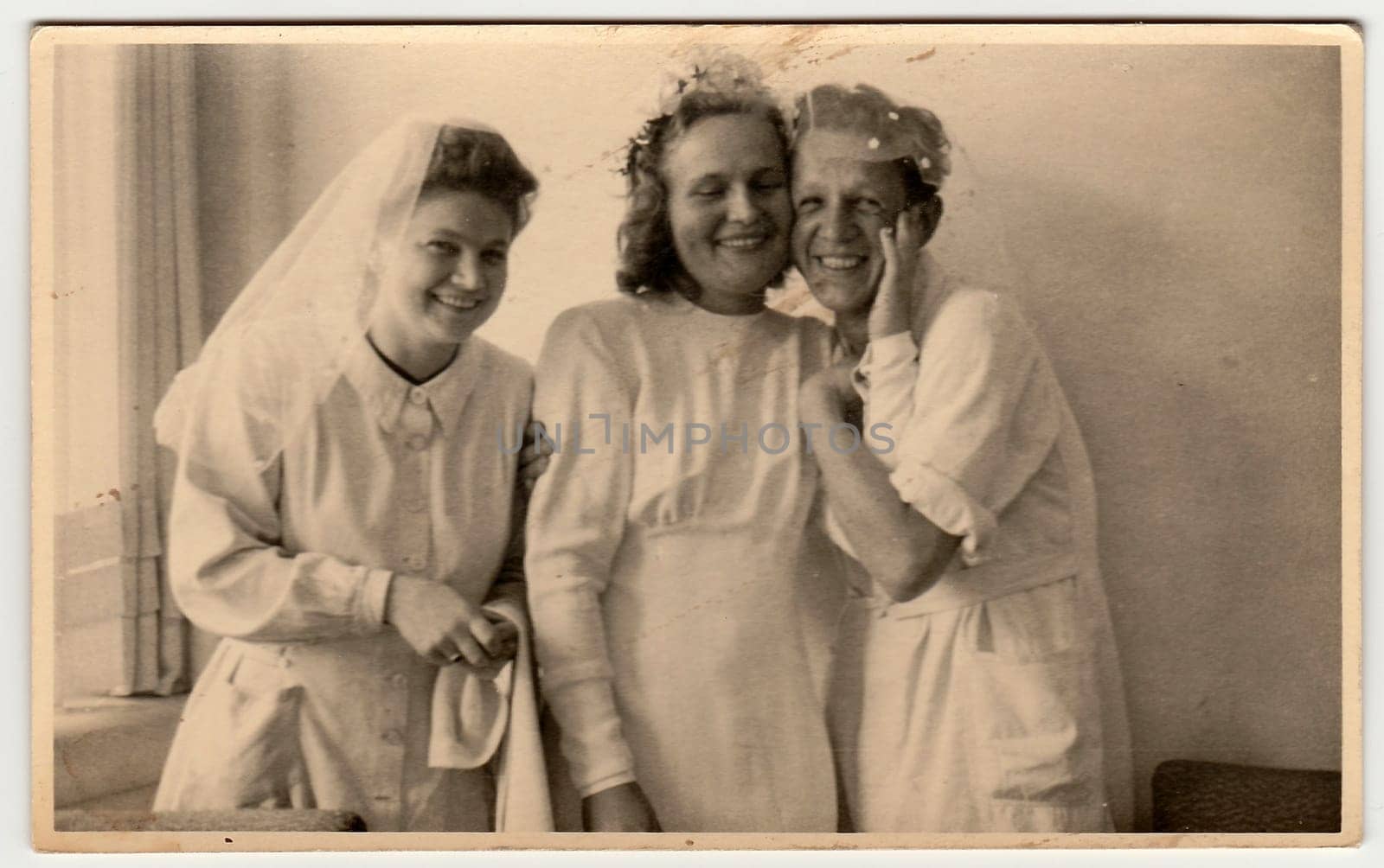 THE CZECHOSLOVAK REPUBLIC - CIRCA 1930s: Vintage photo shows nurses, one of them prepares to wedding ceremony . Black white antique photography.