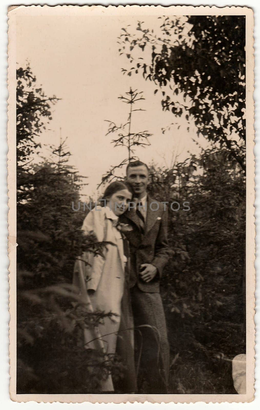 THE CZECHOSLOVAK REPUBLIC - CIRCA 1940s: Vintage photo shows woman and man pose in the forrest. Black white antique photography.