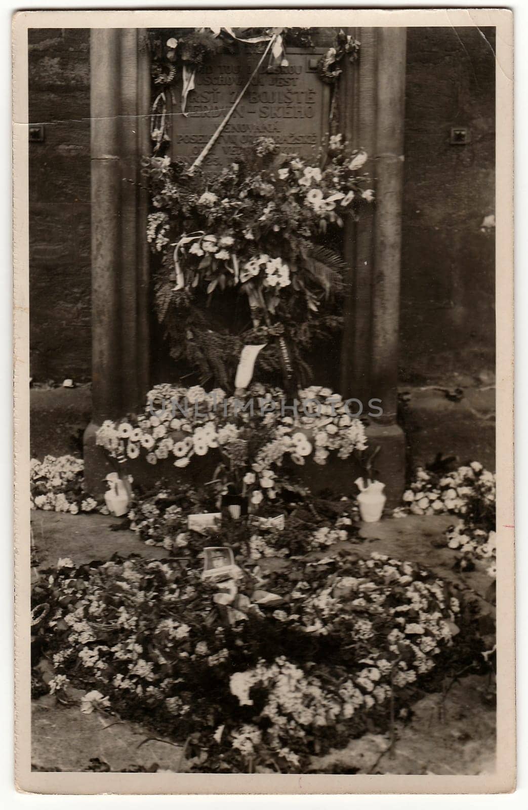 Vintage photo shows tomb with funeral wreath and flowers. Black white antique photography. by roman_nerud