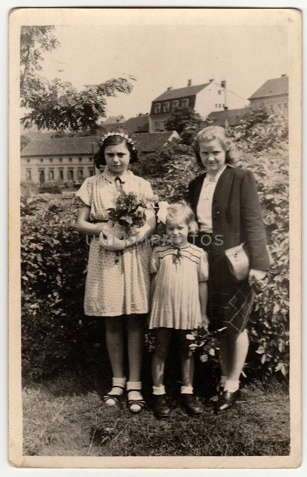 THE CZECHOSLOVAK REPUBLIC - 1946: Vintage photo shows girls with mother after confirmation ceremony. Black white antique photography.