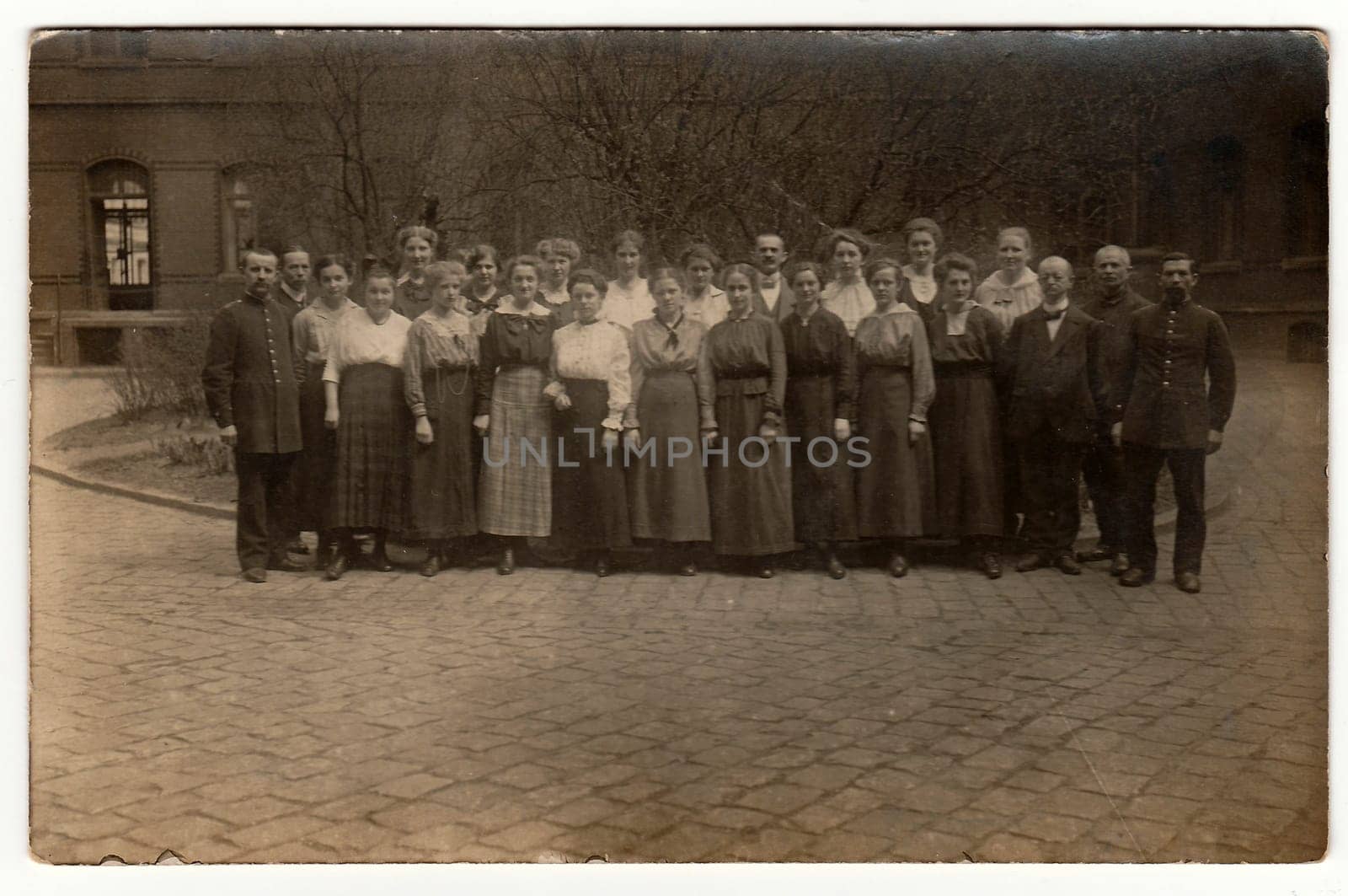 Vintage photo shows a big group of people pose outdoors. Black white antique photography. by roman_nerud