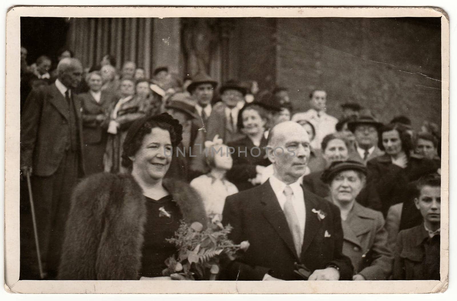 PRAGUE, THE CZECHOSLOVAK SOCIALIST REPUBLIC - JUNE 2, 1951: Vintage photo shows elderly newlyweds after wedding ceremony.