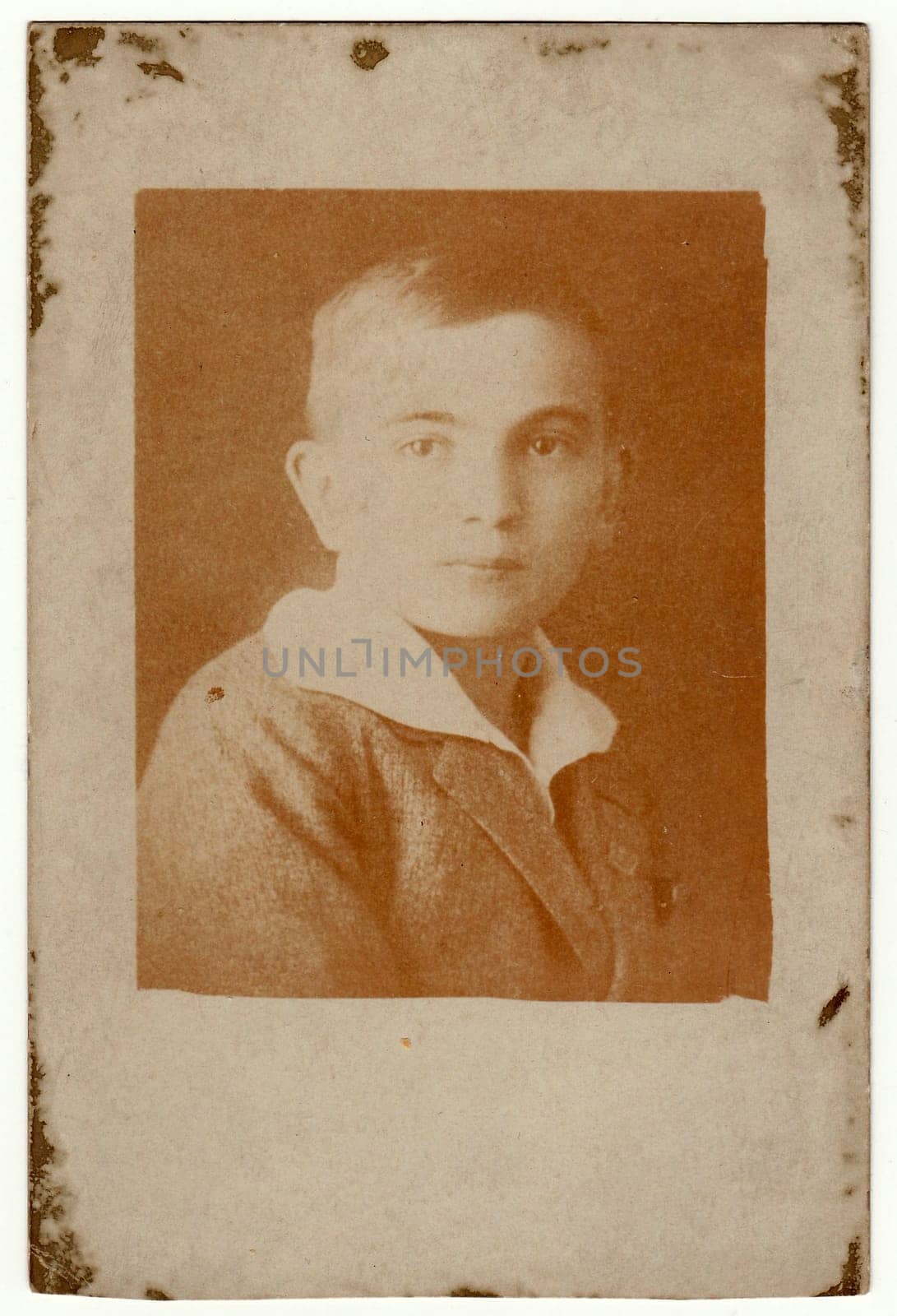 Vintage photo shows face of boy portrait . Antique black white photography. by roman_nerud