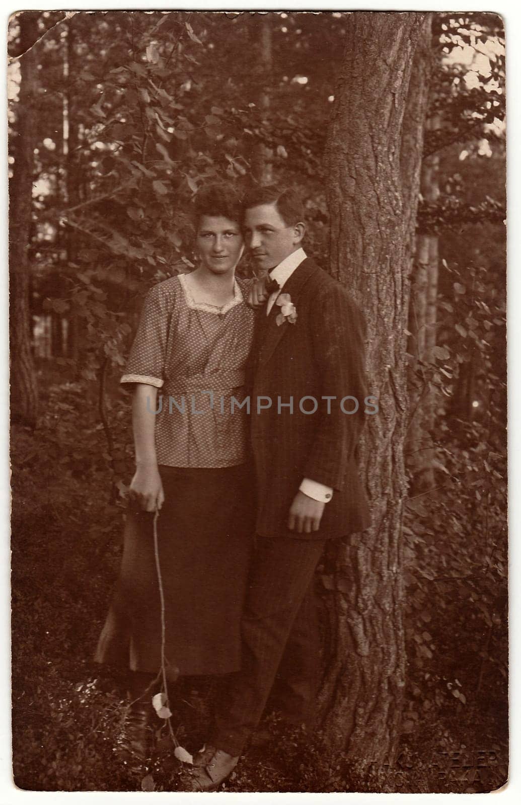 Vintage photo shows young lovers outdoors. Black white antique photography. by roman_nerud