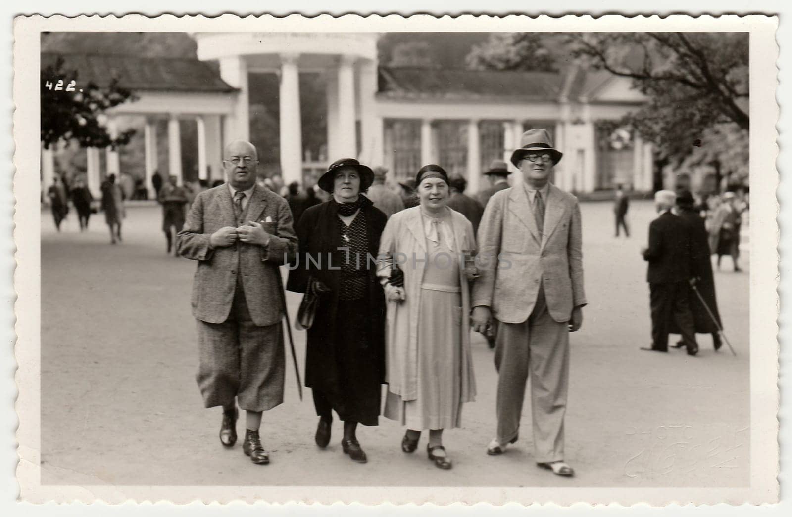 Vintage photo shows mature couples go for a walk in the spa resort. Black white antique photography. by roman_nerud