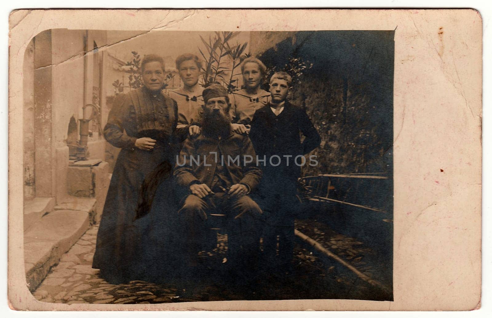 Vintage photo shows rural family poses outdoors. Black white antique photography. by roman_nerud