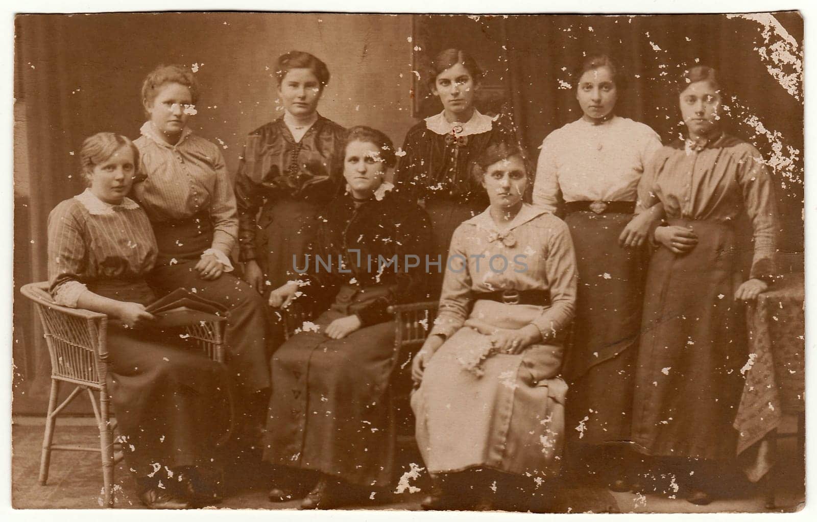 Vintage photo shows group of women pose at the photography studio. Black white antique photography. by roman_nerud