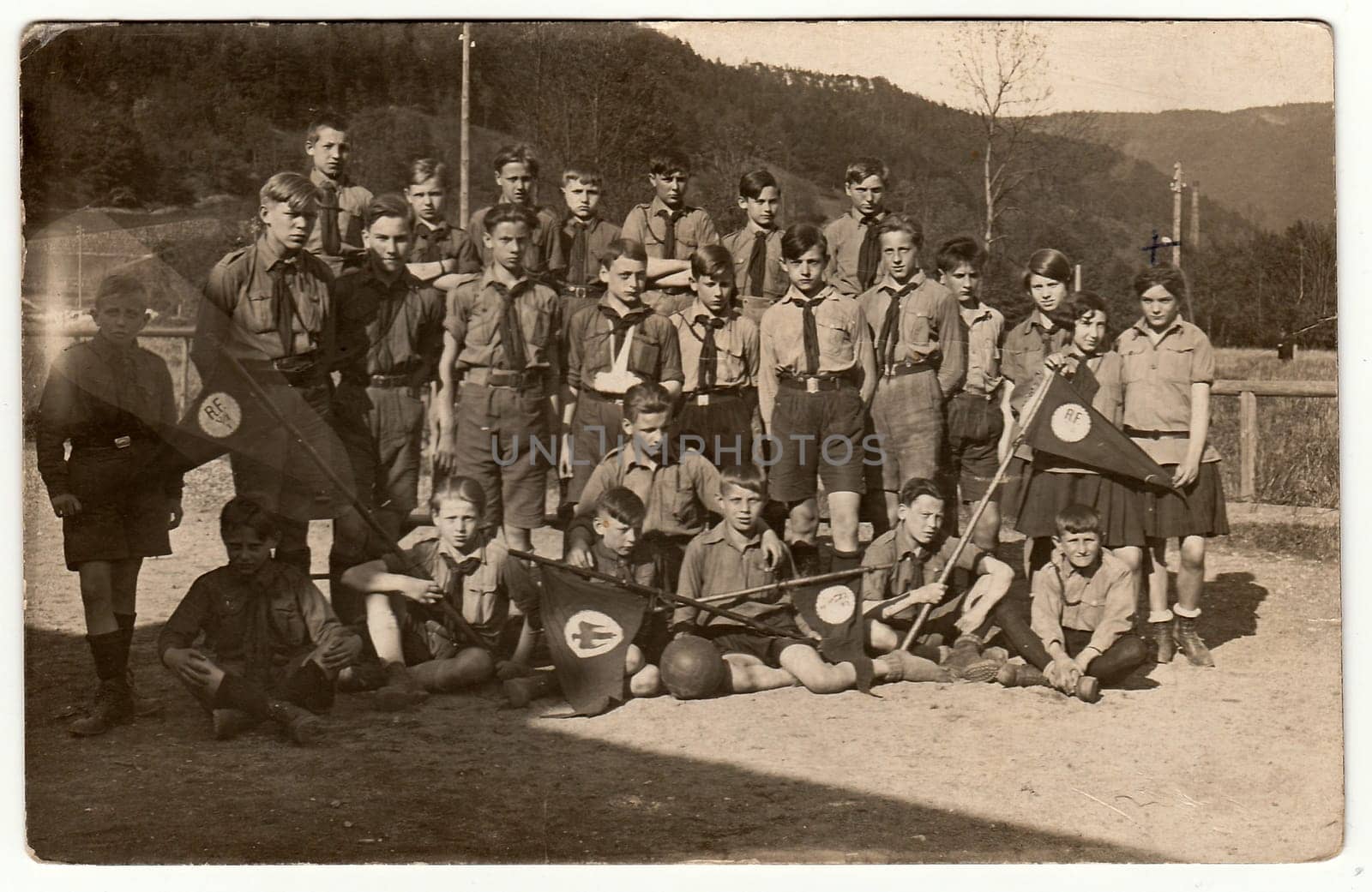 Vintage photo shows boy and girl scouts pfadfinder outdoors. Black white antique photography. by roman_nerud