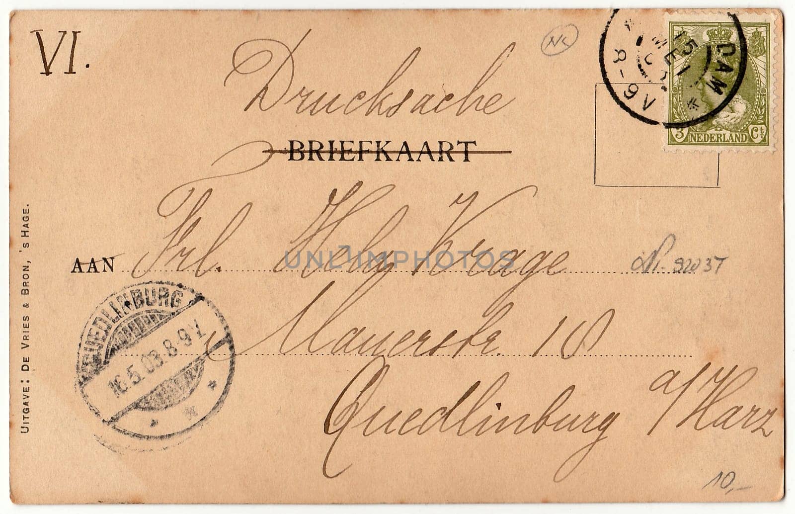 AMSTERDAM, THE NETHERLANDS - MAY 16, 1903: Back of a vintage photo - used postcard. Rich stain and paper details. Can be used as background. Image contains handwriting.