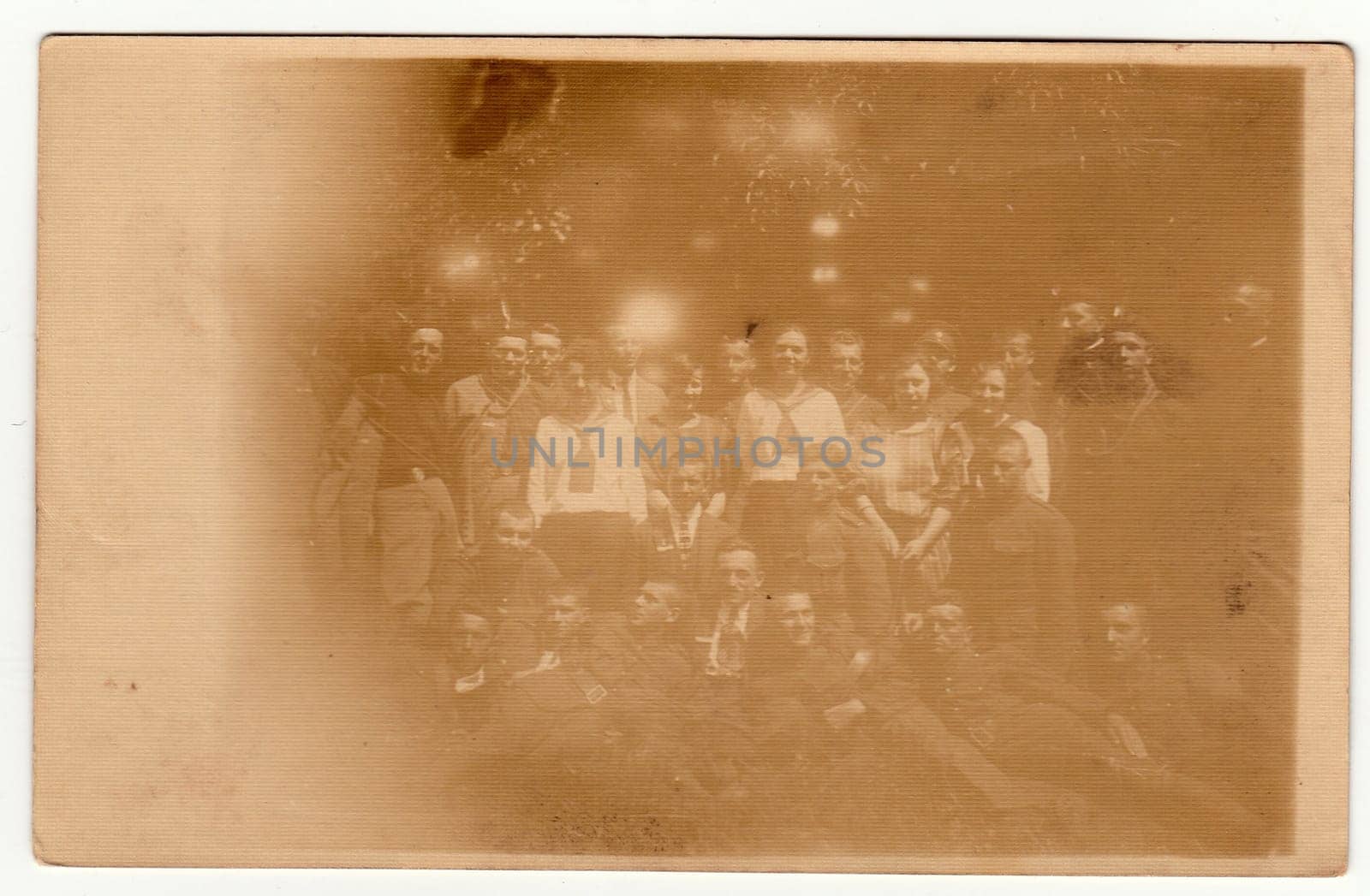 Vintage photo shows a big group of young people pose outdoors. Black & white photography with sepia effect. by roman_nerud