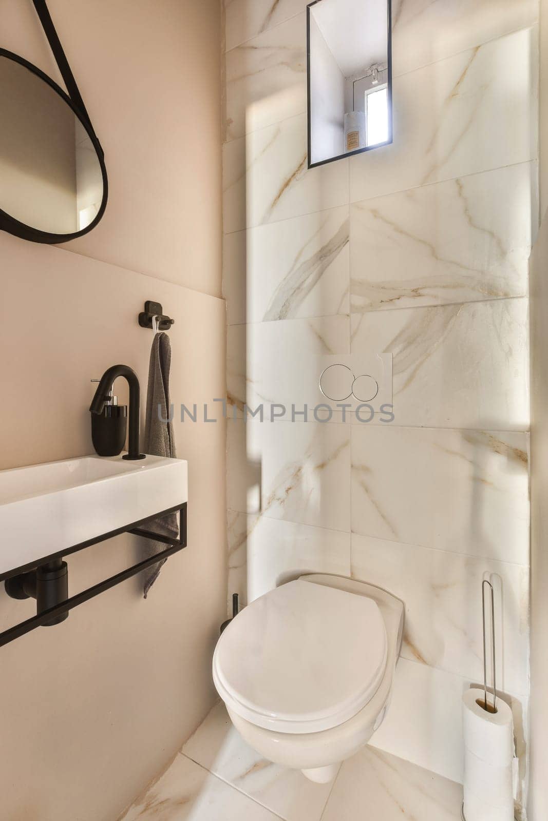 a bathroom with a toilet and mirror in the wall behind it is an image of a man's reflection