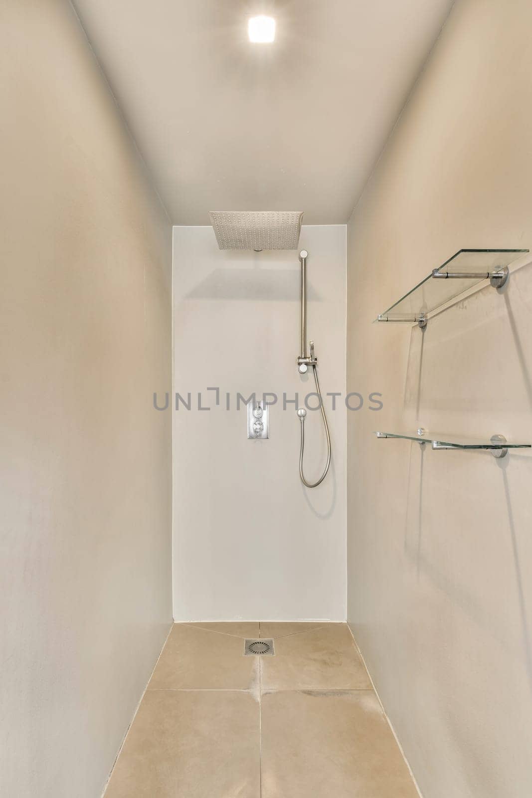 a bathroom with a shower and a white wall by casamedia