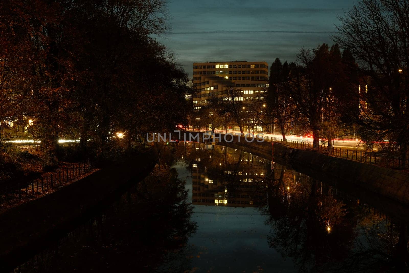 Building reflected in the Spree river at night in autumn in Berlin, Germany