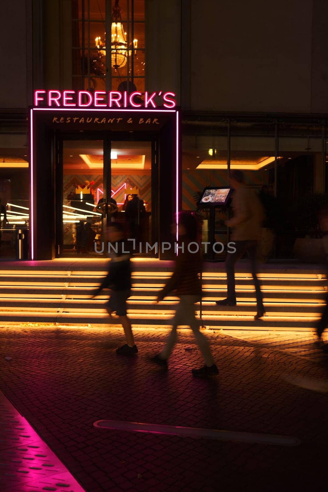 Vertical shot of a neon sign of Frederick's mnear the Sony Center in Berlin, Germany