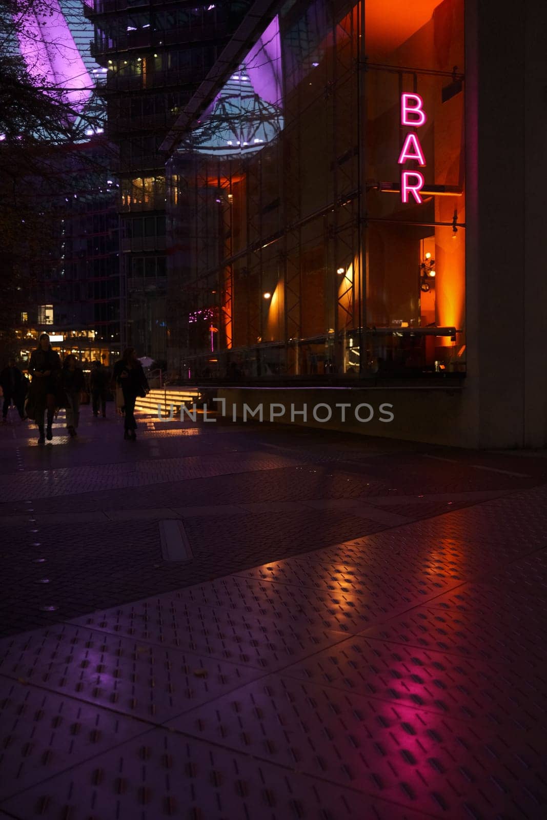 Vertical shot of a neon sign of a bar near the Sony Center in Berlin, Germany