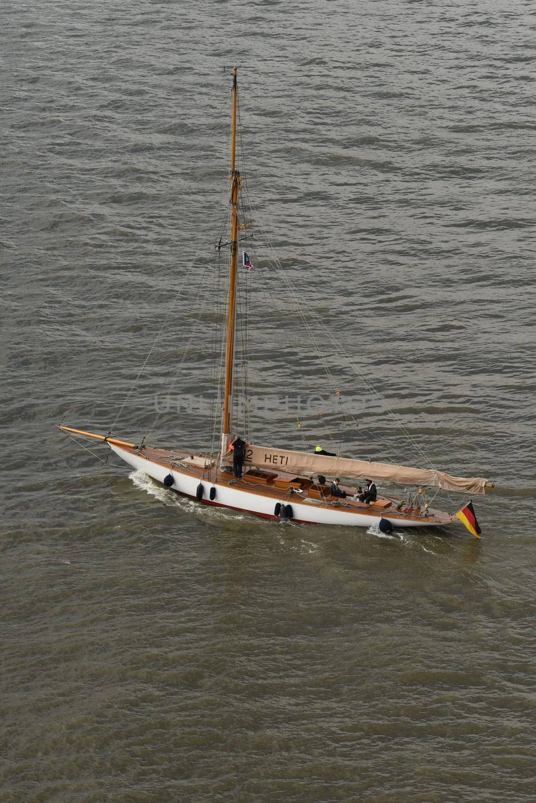 A closeup shot of a wooden sailing boat swimming on shallow waters