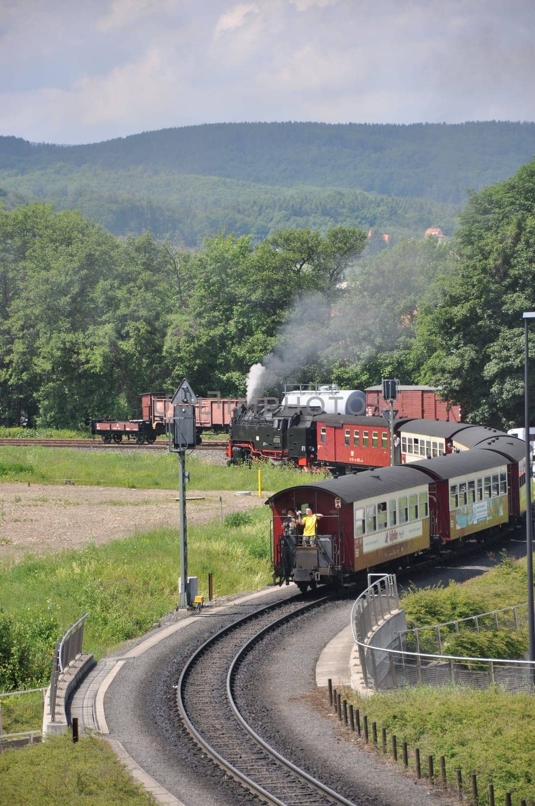 Vertical shot of a steam locomotive with old wagons of Harzer Schmalspurbahnen at the station