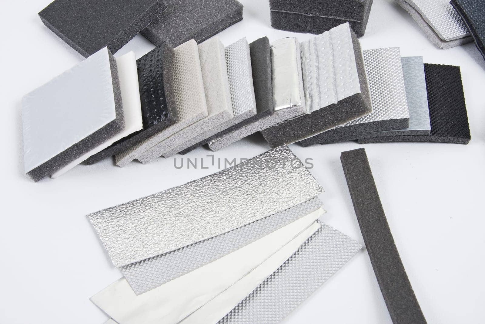 Roll of gray foam rubber sheet isolated in white. High quality photo