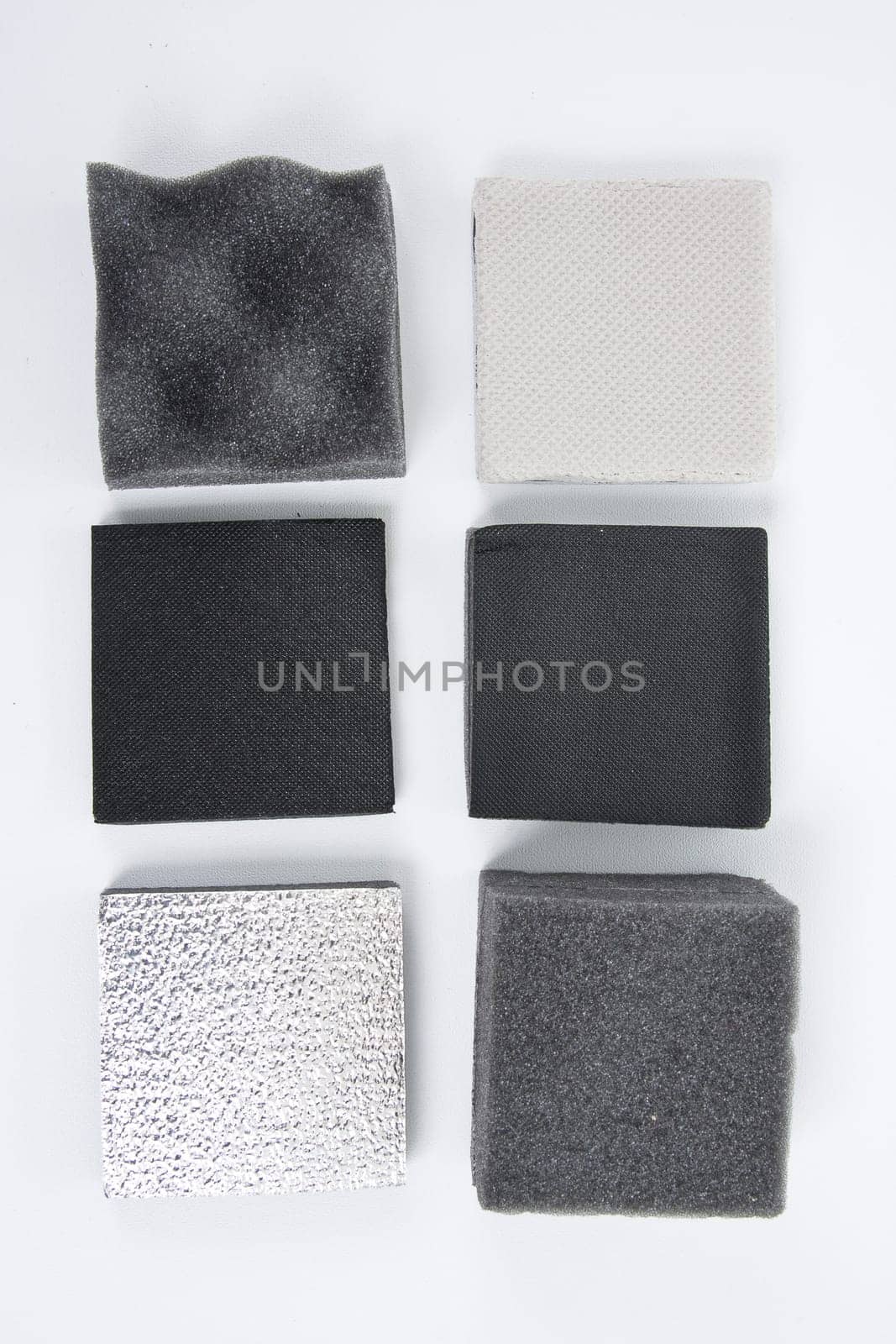 Roll of gray foam rubber sheet isolated in white. High quality photo