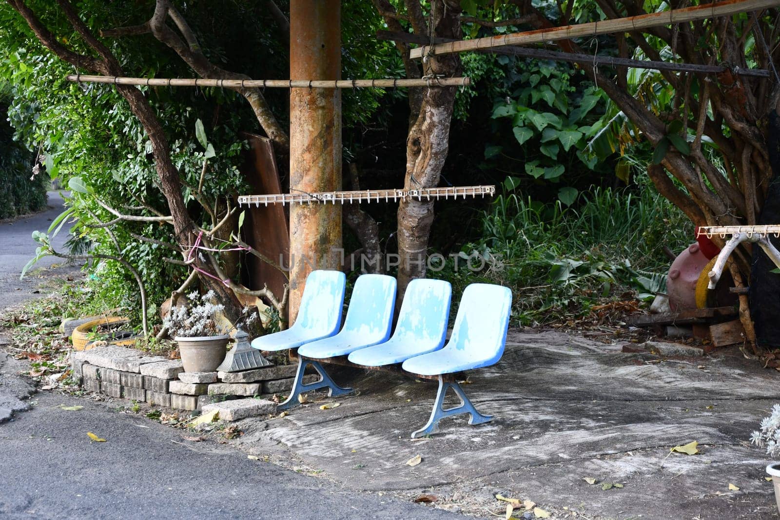 Blue bench made of single chairs near Cape Eluanbi, Taiwan.