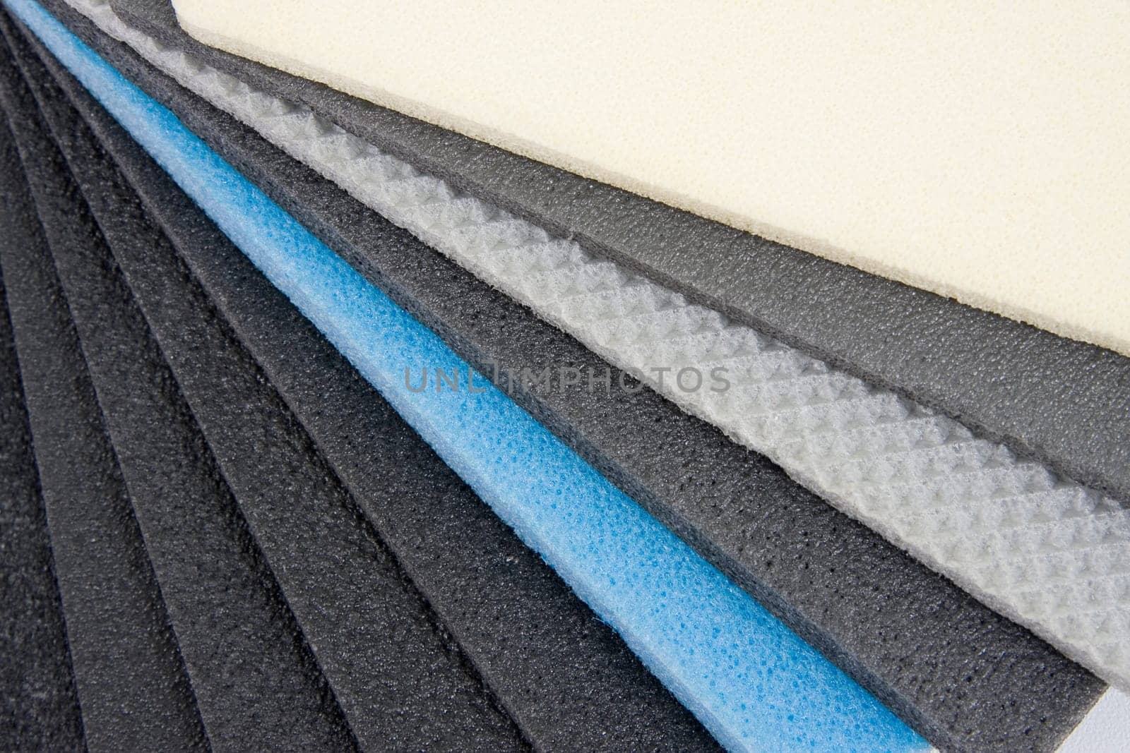 Roll of gray foam rubber sheet isolated in white. High quality photo