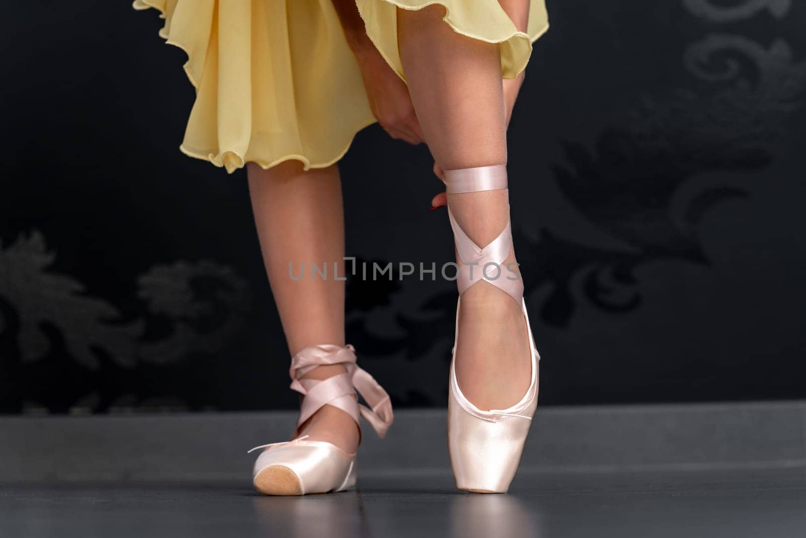 ballet shoes on the feet of a ballerina. High quality photo