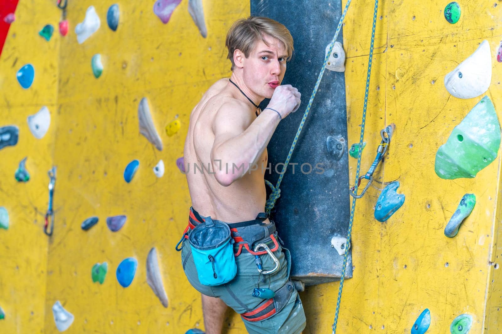 applying magnesium to the hands from the bag before climbing the climbing wall. High quality photo