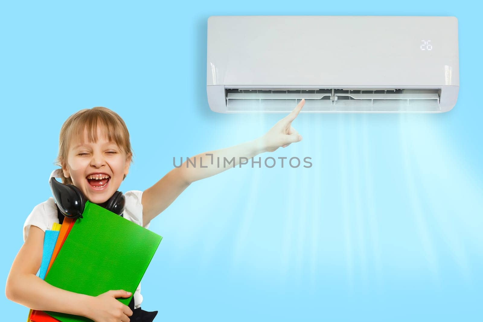 little girl resting under air conditioner on colored wall at home.