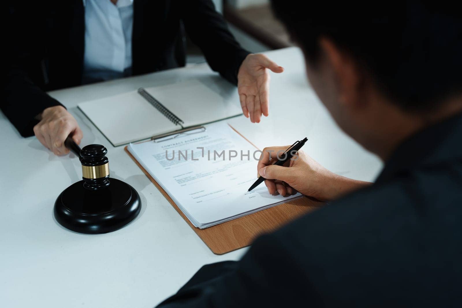 The signing of important documents between the lawyer and the client to enter into an agreement in a court case by Manastrong