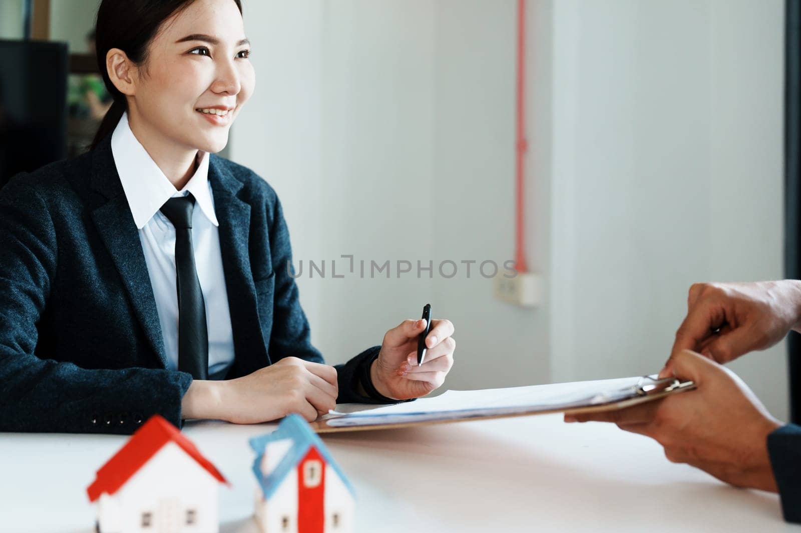 Guarantee, mortgage, agreement, contract, sign, the customer is signing the contract document as evidence to the real estate agent or bank officer according to the agreement according to the document by Manastrong