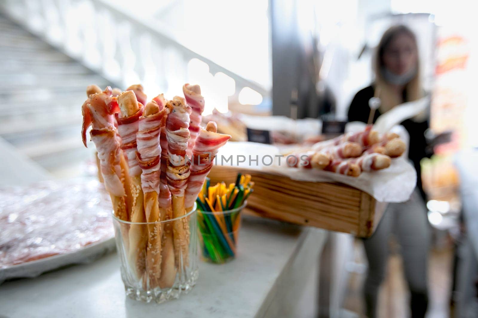 Meat appetizer for a buffet table against the background of a blurred hall.