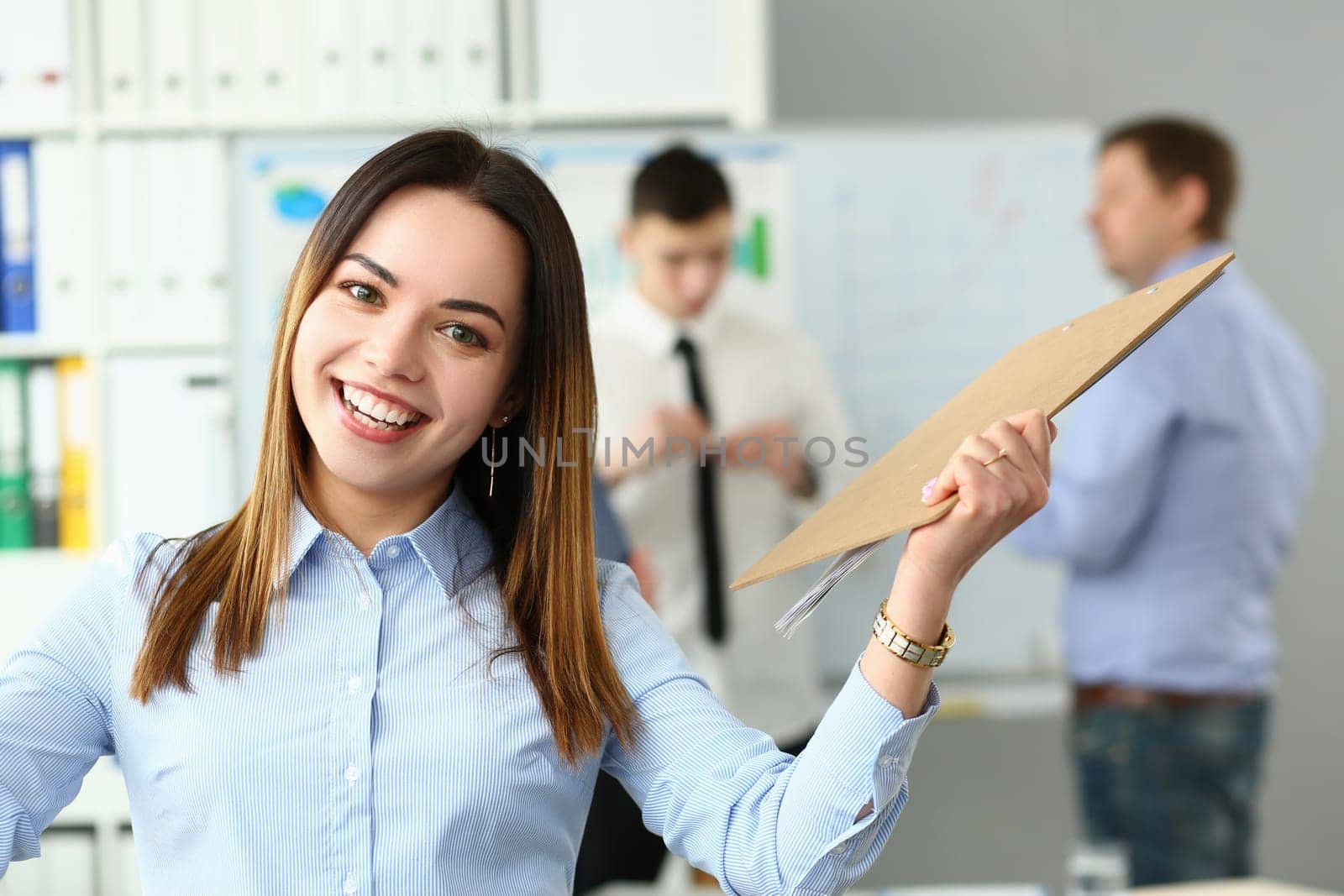 Portrait of a joyful smiling beautiful businesswoman in office by kuprevich