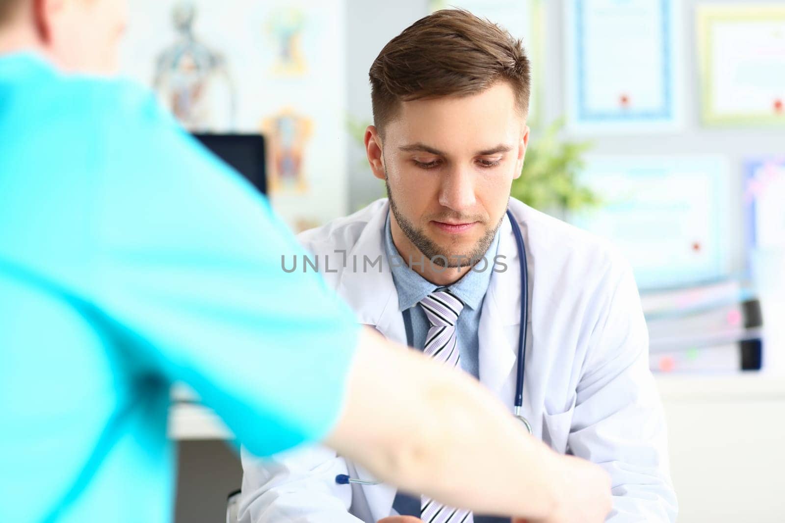 Doctor talks and listens to patient in clinic. Male conversation with urologist concept