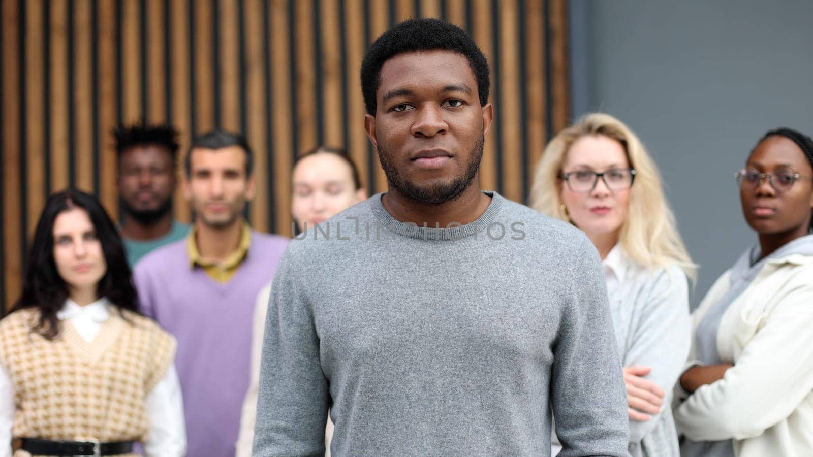 Handsome cheerful african american executive businessman against the background of diverse people