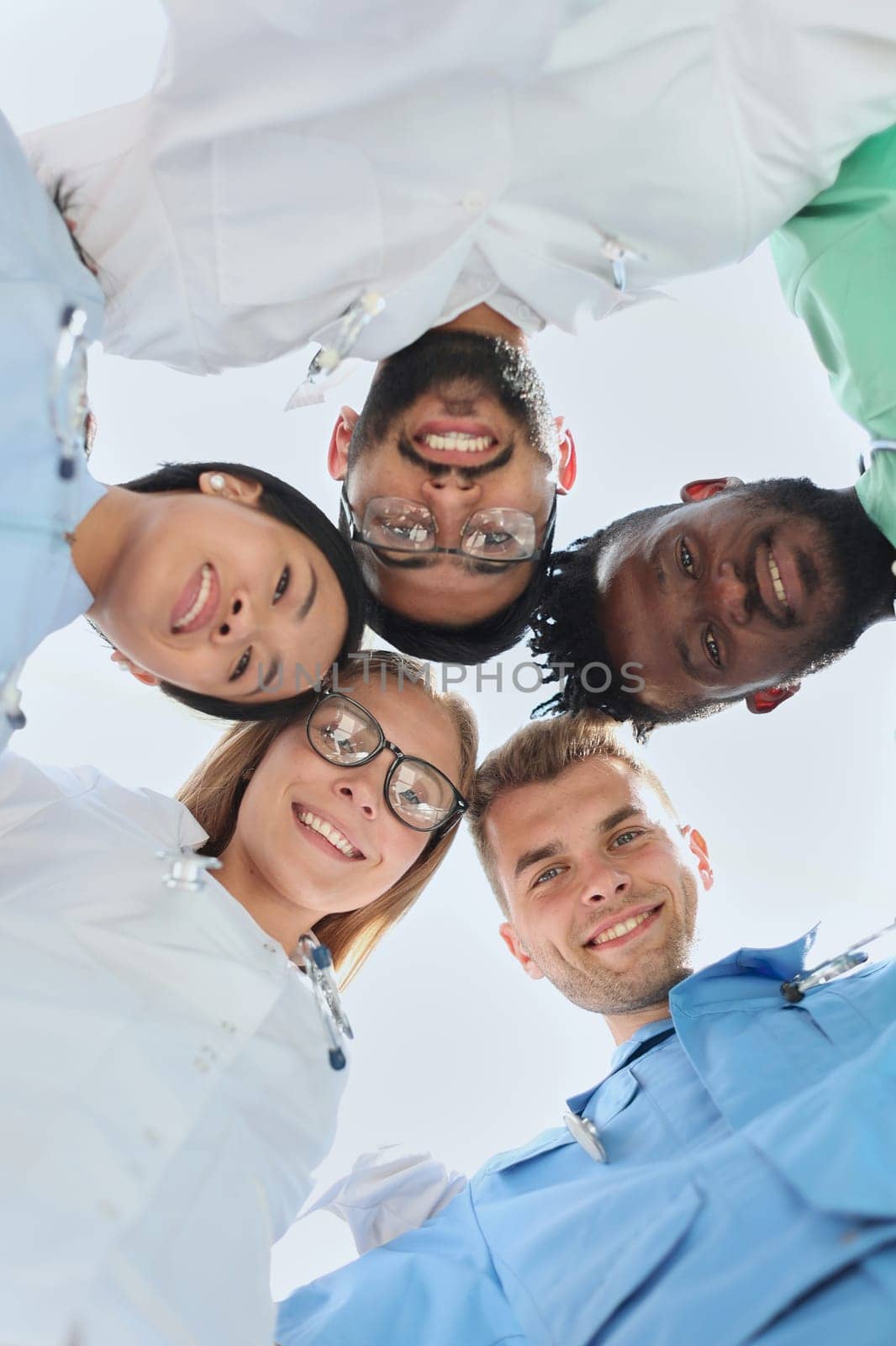 Professional Doctors Holding Each Other Hands. Multinational Medician Meeting. Teamwork Connection. Clinician Team Group. Working Together. Office Friendship. Partnership Arms Shaking.