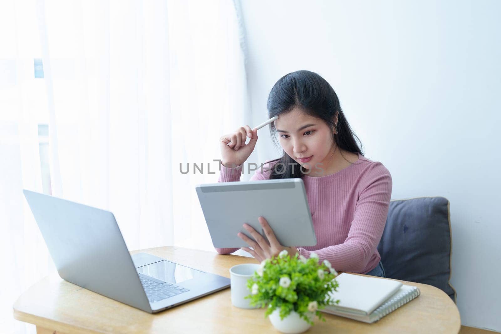 Portrait of a beautiful Asian teenage girl using a tablet computer.